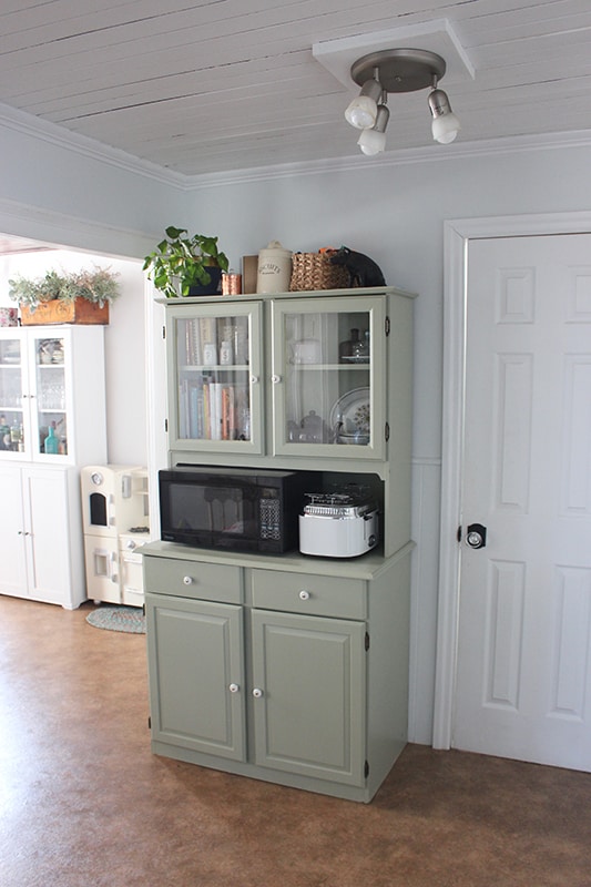 Sage green kitchen with shiplap walls in a Toronto home, Ontario